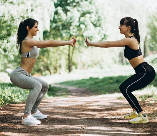 Two fit women warming up-cooling down