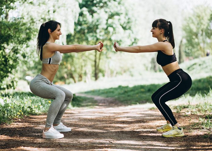 Two fit women warming up-cooling down