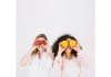 Two happy women having fruits for stress relief
