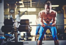 How To Increase your Fitness Program Efficiency? Fit sportsman lifting weight